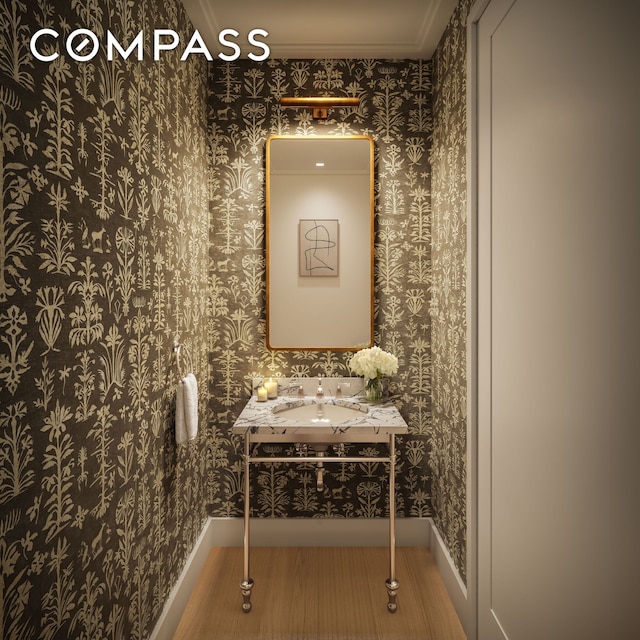 hallway featuring wallpapered walls and baseboards