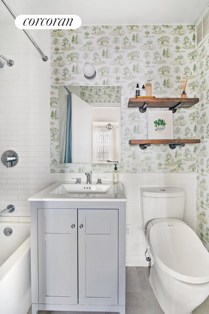 full bathroom featuring toilet, tile patterned flooring, shower / bathtub combination with curtain, and vanity