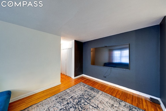 unfurnished room with wood-type flooring