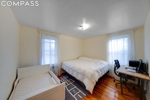 bedroom featuring dark wood-type flooring