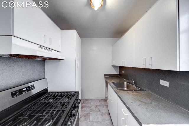 kitchen with sink, white cabinetry, stainless steel gas range, and tasteful backsplash