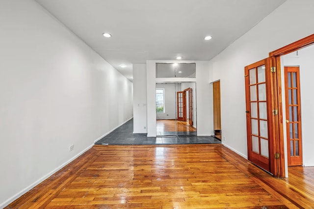 empty room featuring french doors and hardwood / wood-style floors