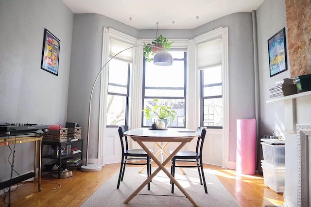 dining space featuring light wood-type flooring and plenty of natural light