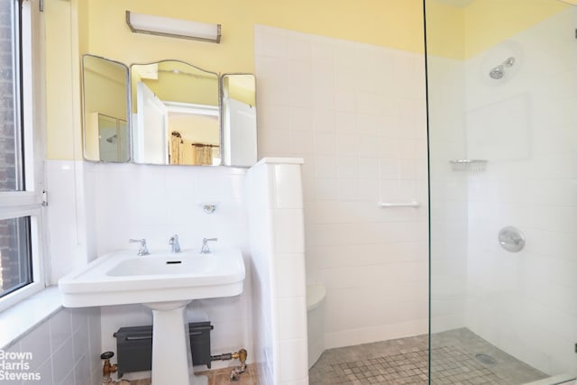 bathroom featuring tile walls and walk in shower
