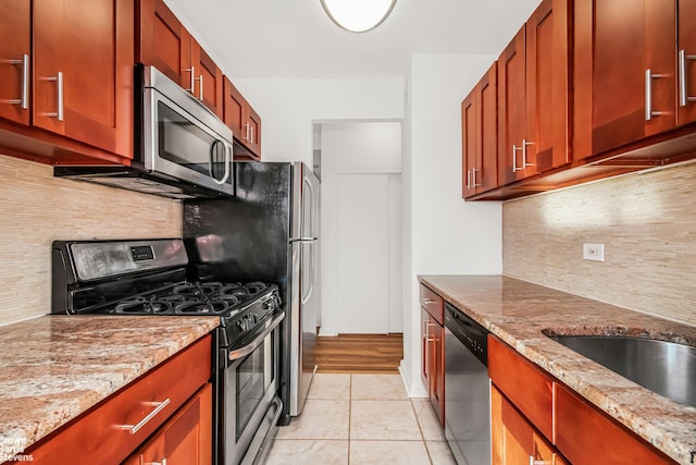3050 Fairfield Ave Unit 8B, New York City, NY 10463 - kitchen with appliances with stainless steel finishes, light tile patterned flooring, backsplash, and light stone counters