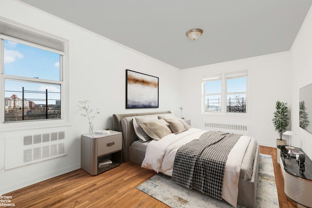 3050 Fairfield Ave Unit 8B, New York City, NY 10463 - bedroom with radiator, wood finished floors, and crown molding