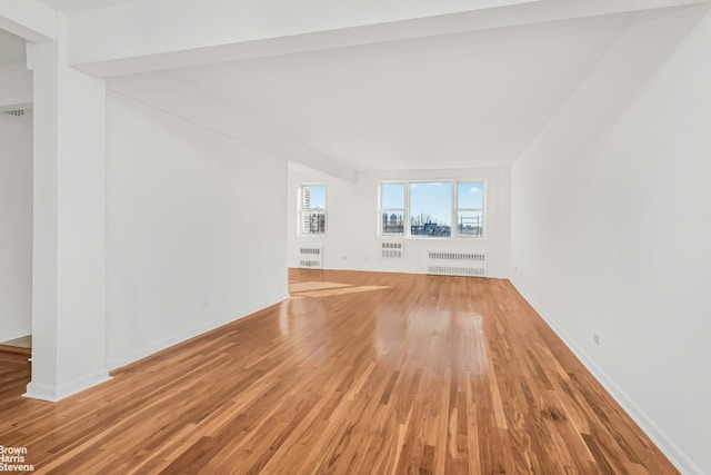 3050 Fairfield Ave Unit 8B, New York City, NY 10463 - unfurnished living room with radiator, light wood-style floors, and baseboards