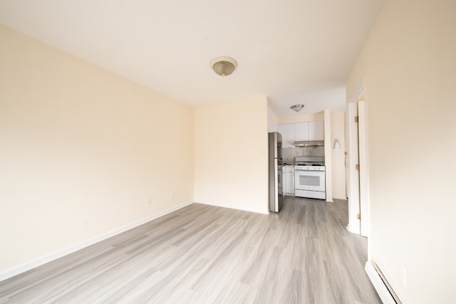 unfurnished living room with baseboard heating and light hardwood / wood-style floors