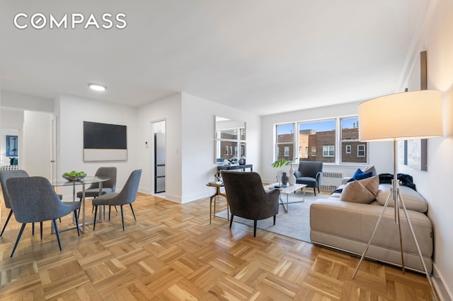 living room with radiator and baseboards