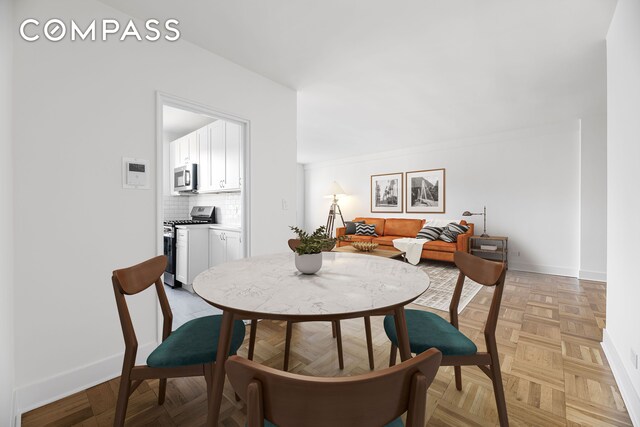 dining room with parquet flooring