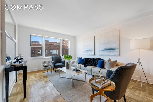 living room with baseboards and radiator heating unit