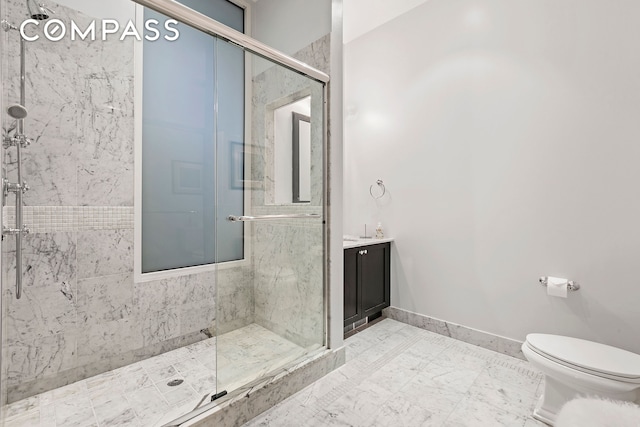 bathroom featuring baseboards, a shower stall, toilet, and vanity