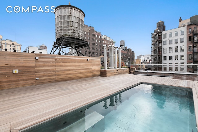 view of swimming pool with a city view