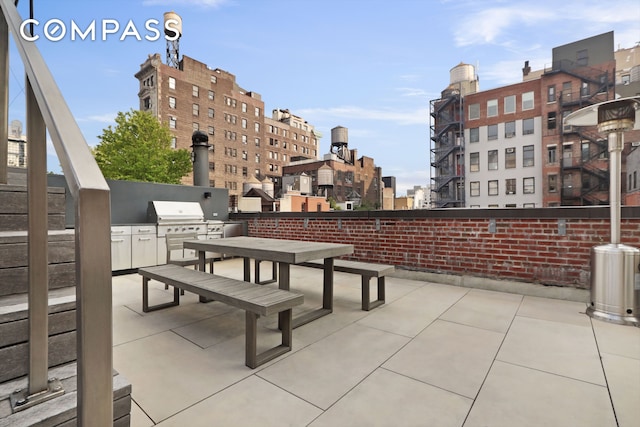 view of patio with a view of city and an outdoor kitchen