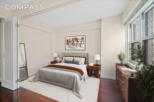 bedroom featuring baseboards and wood-type flooring