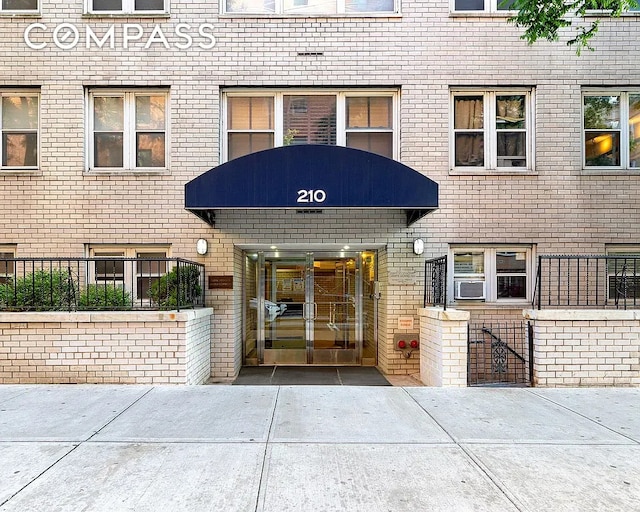 property entrance featuring brick siding