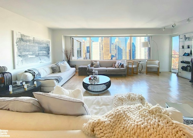 living room featuring parquet flooring and rail lighting