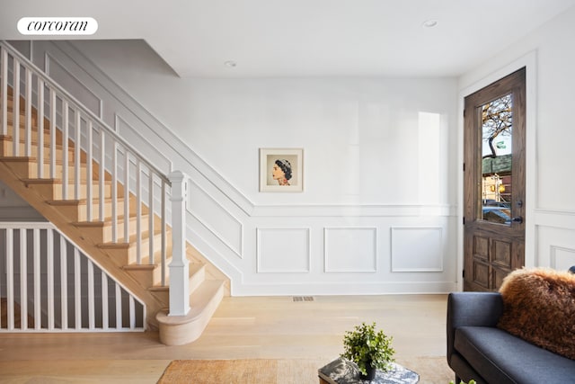 entryway with hardwood / wood-style flooring