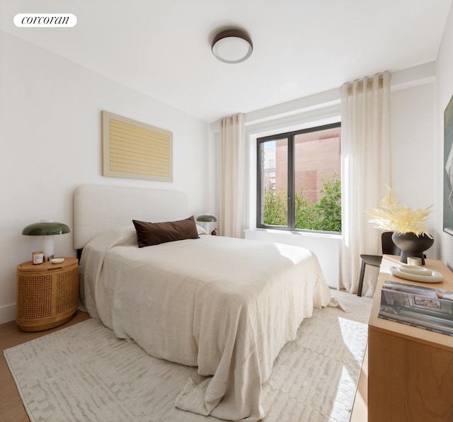 bedroom featuring visible vents and wood finished floors