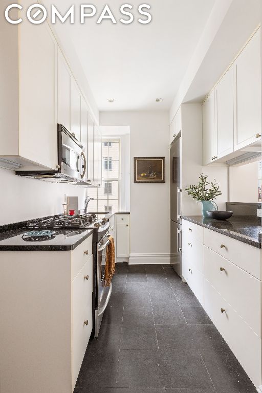 kitchen with white cabinets and appliances with stainless steel finishes