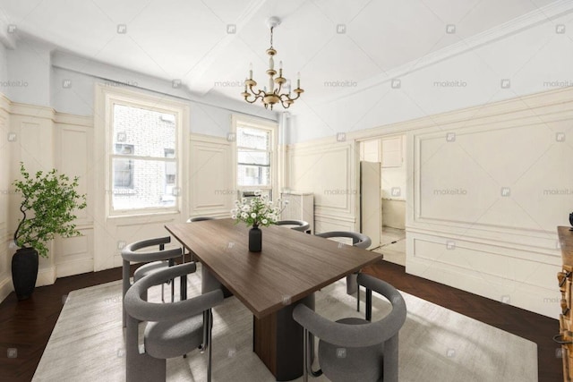 dining space featuring ornamental molding and an inviting chandelier