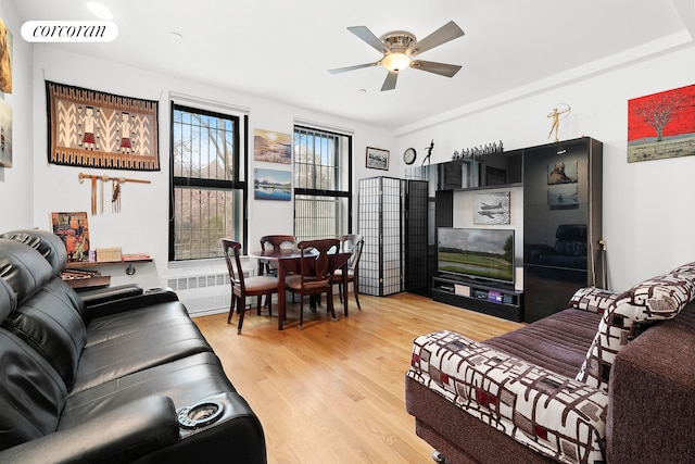 250 Manhattan Ave Unit 1A, New York City, NY 10026 - living area featuring light wood-style floors, radiator, and a ceiling fan