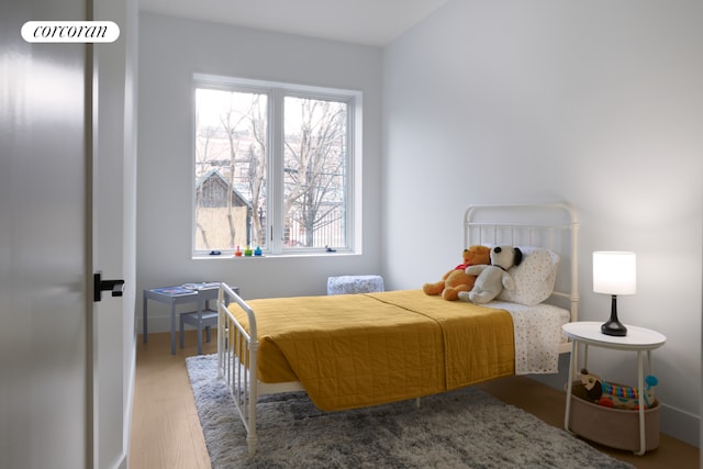 bedroom with hardwood / wood-style flooring