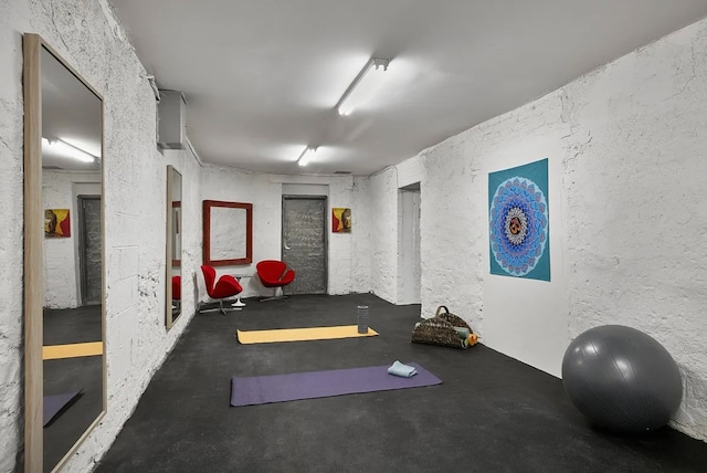 workout room featuring a textured wall