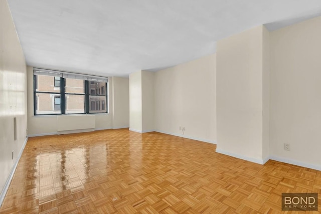 unfurnished room featuring light parquet floors