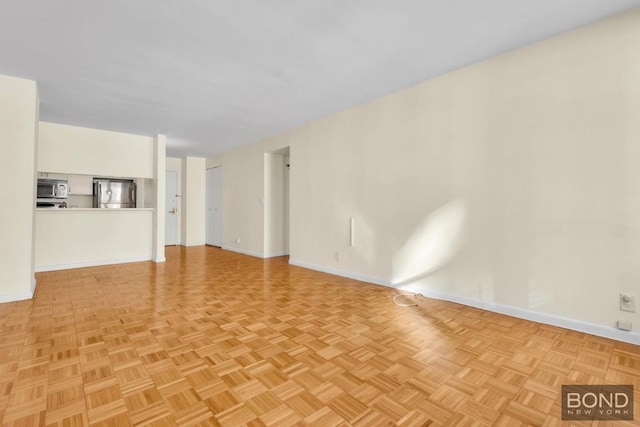 unfurnished living room featuring light parquet flooring