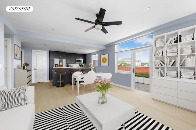 living room with light hardwood / wood-style floors and ceiling fan