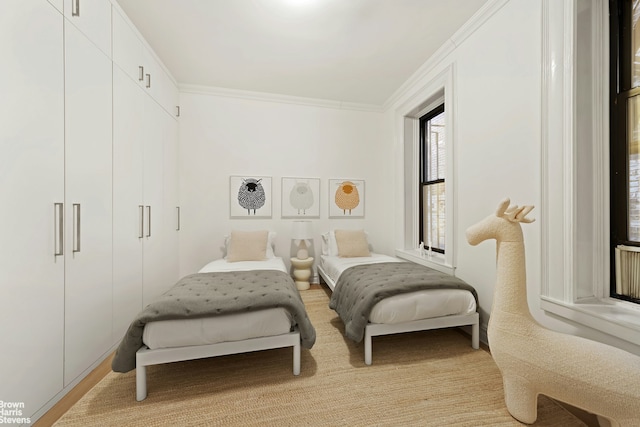 bedroom featuring a closet and crown molding