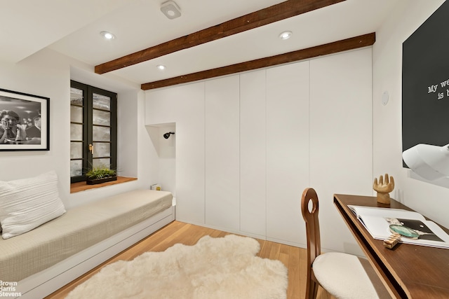 bedroom with beam ceiling, wood finished floors, and recessed lighting