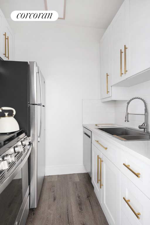 kitchen with white cabinetry, sink, dark hardwood / wood-style flooring, and decorative backsplash