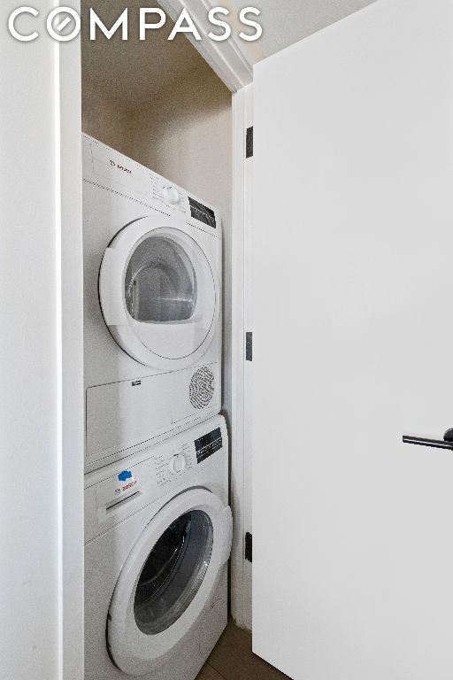 laundry area featuring stacked washer and dryer