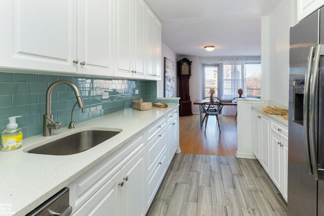 dining space featuring sink and light hardwood / wood-style flooring