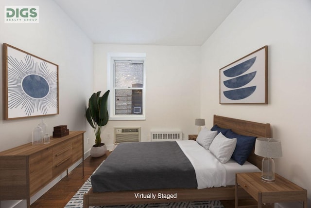 bedroom featuring dark wood-type flooring and a wall mounted air conditioner