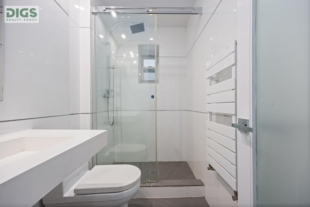 bathroom with toilet, tile patterned floors, and walk in shower