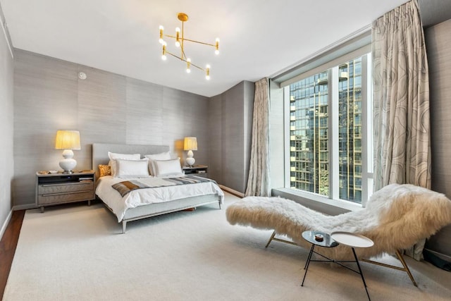 bedroom with a notable chandelier and multiple windows