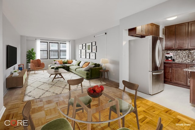 living room with light parquet flooring and sink