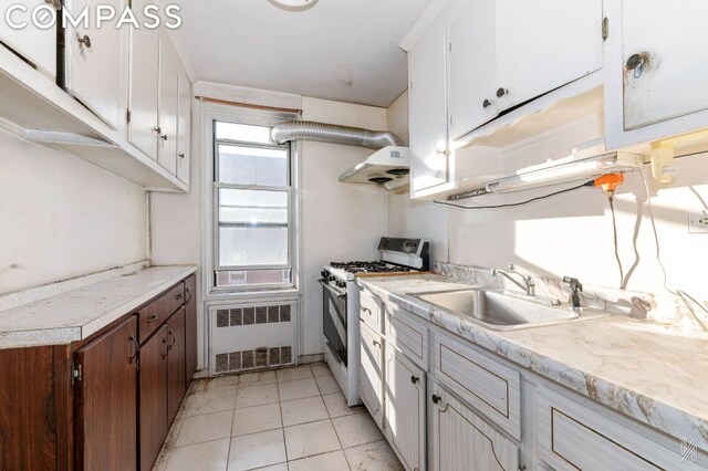 bathroom with sink, tile walls, and combined bath / shower with glass door