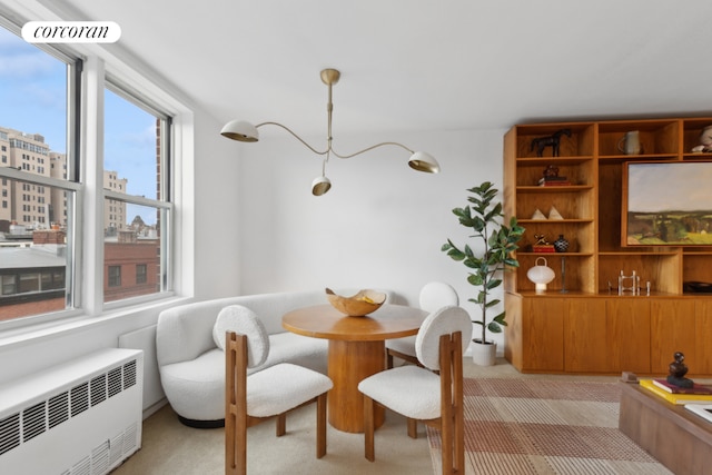 carpeted dining space featuring radiator