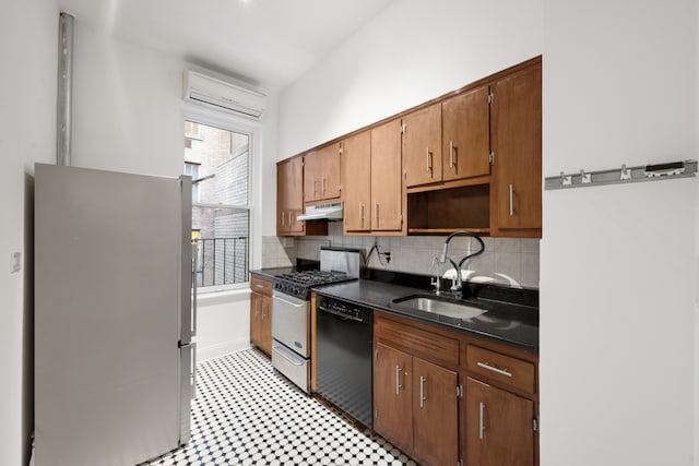 kitchen with freestanding refrigerator, gas range oven, under cabinet range hood, a sink, and dishwasher