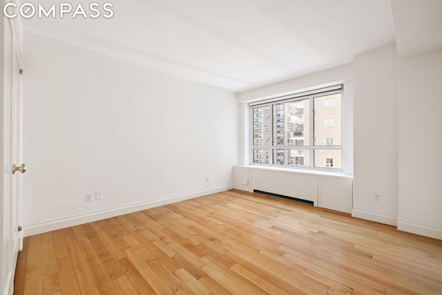 spare room featuring light hardwood / wood-style floors