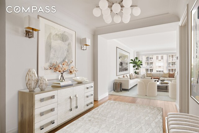 200 E 66th St Unit D1203, New York City, NY 10065 - hallway featuring wood finished floors, radiator, crown molding, baseboards, and a chandelier