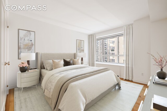 200 E 66th St Unit D1203, New York City, NY 10065 - bedroom featuring light wood-type flooring and baseboards
