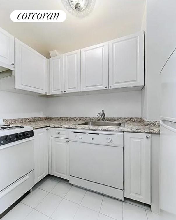 kitchen featuring dishwasher, sink, white cabinetry, light stone counters, and range