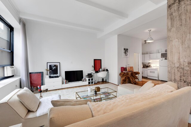 250 Mercer St Unit B603, New York City, NY 10012 - living room with beamed ceiling and light wood-style flooring