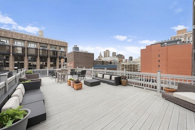 wooden deck with outdoor dining space, an outdoor living space, and a view of city