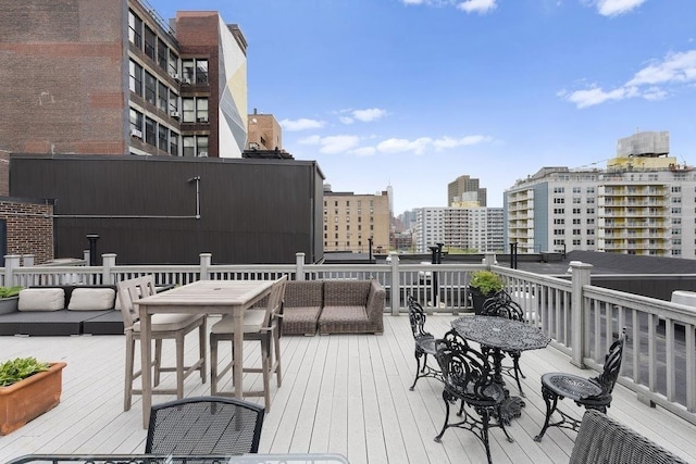 wooden deck featuring a city view and an outdoor hangout area